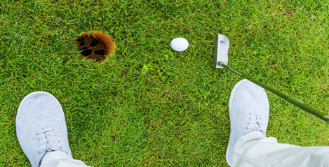 A person playing golf on a grass field